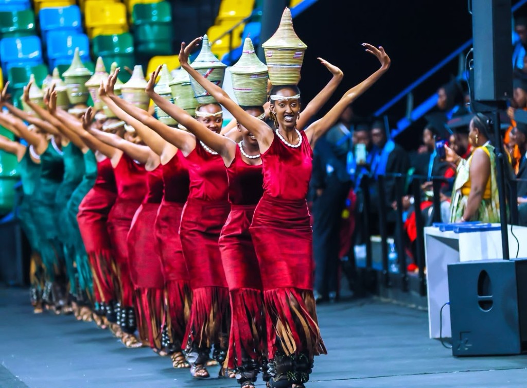 Women dancing with traditional agaseke baskets on stage