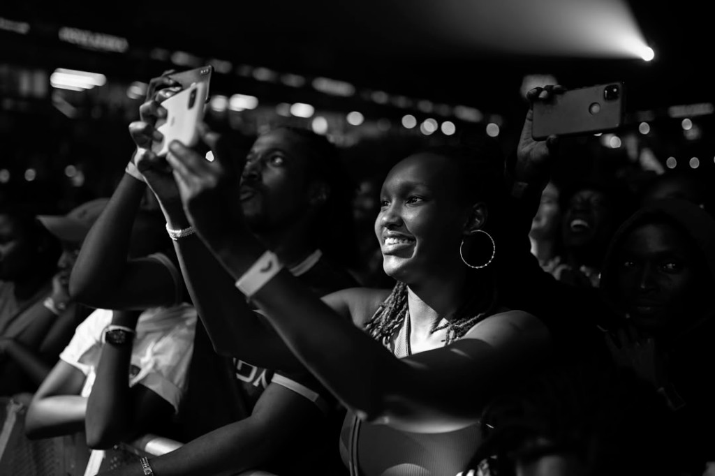 Youth recording a community event on smartphones